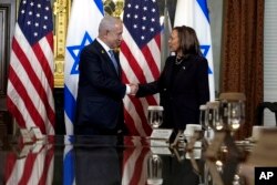 Vice President Kamala Harris shakes hands with Israeli Prime Minister Benjamin Netanyahu before a meeting at the Eisenhower Executive Office Building on the White House complex in Washington, July 25, 2024.