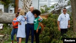 US President Joe Biden and first lady Jill Biden speak with a woman during their tour of Hurricane Idalia storm destruction, Live Oak, Florida, Sept. 2, 2023. 