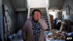 Olena Archipenko pauses as she prepares bread to be distributed to her neighbors in the Siversk, Donetsk region on May 2, 2023, during the Russian invasion of Ukraine.