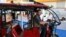 FILE - An exhibitor sits inside an E-rickshaw on display during the Hyderabad E-Motor Show at Hitex Exhibition Centre in Hyderabad, Feb. 8, 2023. 