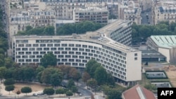 FILE - A photograph taken from the top of the Eiffel Tower shows an aerial view of Paris, with the UNESCO headquarters building, July 15, 2020.