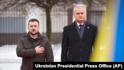 In this photo provided by the Ukrainian Presidential Press Office, Lithuania's President Gitanas Nauseda, right, and Ukrainian President Volodymyr Zelenskyy attend a ceremony in Vilnius, Lithuania, Jan. 10, 2024. (Ukrainian Presidential Press Office via AP)