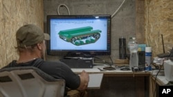 Serhii, chief engineer of design and production bureau "UkrPrototyp," works on a 3D model of a car-sized 800-kilogram prototype ground drone, in northern Ukraine, June 27, 2024.