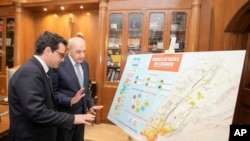 Lebanese Parliament Speaker Nabih Berri, right, shows a map that details Israel's strikes on Lebanon since Oct. 7, to visiting French Foreign Minister Stephane Sejourne during their meeting, in Beirut, April 28, 2024. 