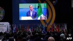 Delegates watch a screen that broadcasts a speech of President of the African Development Bank Akinwumi Adesina at the Kenyatta International Convention Centre in Nairobi on May 29, 2024.