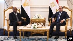 In this photo provided by the media office of Egypt's presidency, Egyptian President Abdel-Fattah el-Sissi, right, meets with Sudan's army chief General Abdel Fattah al-Burhan, at the Presidential palace in el-Alamein city, Egypt, Aug. 29, 2023.