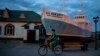 A boy rides a bicycle in what used to be the main port of Aralsk, Kazakhstan, before the Aral Sea dried up, July 4, 2023. 