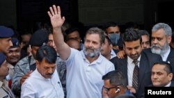 Rahul Gandhi, a senior leader of India's main opposition Congress party, waves as he leaves a court after he lodged an appeal against his conviction for defamation, in Surat in the western state of Gujarat, India, April 3, 2023. 