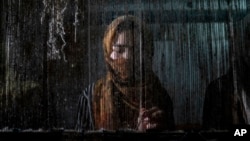 A woman weaves a traditional Afghan carpet at a factory in Kabul, Afghanistan, March 6, 2023. In December 2022, the Taliban banned women from working for nongovernmental organizations.