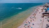FILE - People on vacation enjoy the beach at Kyrylivka on the Sea of Azov in southern Ukraine. (Adobe Stock Photo by Denis Chubchenko)