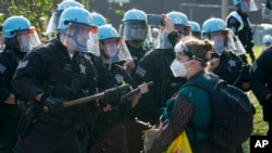 A protester confronts police during a demonstration at the Democratic National Convention, Aug. 19, 2024, in Chicago.