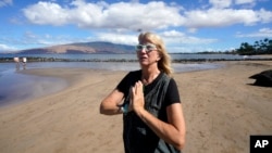 Anne Landon stands on a beach in Kihei, Hawaii, Aug. 15, 2023. The evacuation center at the South Maui Community Park Gymnasium is now her safe space, where she has a cot and access to food, water, showers, books and puzzles.