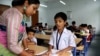 An instructor helps a student at an English modernized madrasa in West Bengal, India, April 2, 2024. (Shaikh Azizur Rahman/VOA)