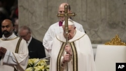 Pope Francis holds the pastoral staff as he presides over Christmas Eve Mass, at St. Peter's Basilica at the Vatican, Dec. 24, 2023.