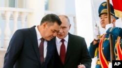 FILE - Kyrgyzstan's President Sadyr Japarov, left, and Russian President Vladimir Putin attend a welcome ceremony prior to their talks in Bishkek, Kyrgyzstan, Oct. 12, 2023. 