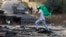 A Palestinian youth holds a Hamas flag during confrontations with Israeli troops at the northern entrance of Ramallah, West Bank, near the Israeli settlement of Beit El, Oct. 27, 2023, as battles continue between Israel and Hamas.