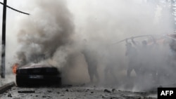 Des pompiers libanais éteignent le feu dans une voiture après une attaque israélienne dans la ville de Sidon, le 21 août 2024. Une frappe israélienne dans le sud du Liban a tué un responsable du Fatah, a déclaré un dirigeant du groupe palestinien.