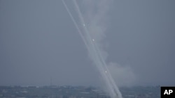 Rockets are fired towards Israel from the Gaza Strip, Oct. 9, 2023. Major airlines have suspended flights in and out of Israel after the nation declared war following a massive attack by Hamas.