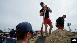 Long Beach lifeguards fill up sandbags for residents ahead of Hurricane Hilary in Long Beach, Calif., Aug. 19, 2023.