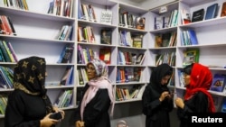 FILE - Afghan women attend the inauguration of women's library in Kabul, August 24, 2022. 