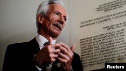 FILE - Journalist Jose Zamora, founder and president of El Periodico newspaper, talks with the media as he attends a court hearing in Guatemala City, Guatemala, Dec. 8, 2022. 