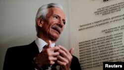 FILE - Journalist Jose Ruben Zamora, founder and president of El Periodico newspaper, talks with reporters as he attends a court hearing in Guatemala City, Guatemala, Dec. 8, 2022. 