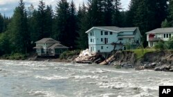 The swollen Mendenhall River courses along a neighborhood in Juneau, Alaska, Aug. 6, 2023.
