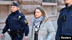Police officers detain the climate activist Greta Thunberg during a climate action outside the Swedish parliament Riksdagen, in Stockholm, Sweden, March 12, 2024.