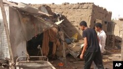 People check the rubble of their destroyed home after strikes at Allamat district in Khartoum, Sudan, June 1, 2023.