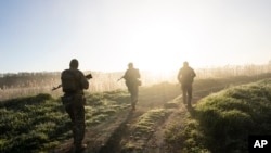 Ukrainian Border Guard soldiers participate in a military exercise in central Ukraine, May 2, 2023.