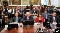FILE - Former President Donald Trump sits in the courtroom with his legal team before the continuation of his civil business fraud trial at New York State Supreme Court, Oct. 3, 2023, in New York. Trump's bid to postpone the trial was rejected Oct. 6.