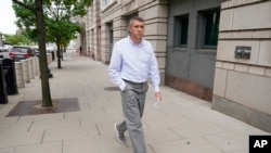 FILE - Shane Lamond departs federal court after pleading not guilty to obstruction of justice and other charges in Washington, May 19, 2023. He retired from the Metropolitan Police Department the same month. 