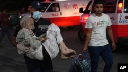 Palestinian wounded in the Israeli bombardment of the Gaza Strip are brought to Al Asa Hospital in Deir el-Balah on Oct. 21, 2023.