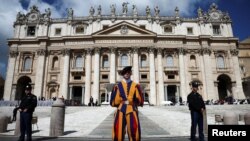 FILE - Two Gendarmerie officers and a Swiss guard stand guard as Pope Francis holds the weekly general audience, in Saint Peter Square at the Vatican, May 22, 2024. 