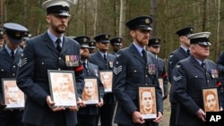 British soldiers mark the 80th anniversary of the 'Great Escape,' when Allied POWs tunneled out of Stalag Luft III, only three made it to safety, in Zagan, Poland, March 24, 2024.