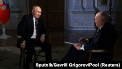 Russian President Vladimir Putin speaks with Director General of Rossiya Segodnya media group Dmitry Kiselyov during an interview in Moscow, March 12, 2024.