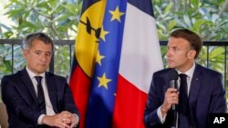 French President Emmanuel Macron, right, speaks as sits next to France's Minister for Interior and Overseas Gerald Darmanin in Noumea, New Caledonia, May 23, 2024. 