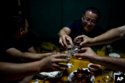 Men enjoy their time in a restaurant in Nukus, Uzbekistan, June 23, 2023.