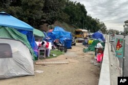 FILE - Tenda berjajar di jalan layang di North Hill Street di atas Cesar Chavez Avenue dekat A.S. 101 di Los Angeles, November. 15, 2023. (AP/Christopher Weber)