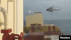 FILE - In this photo taken from video, an Iranian commando rappels from a helicopter in a raid on the MSC Aries in the Strait of Hormuz on April 13, 2024.