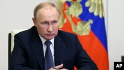 FILE - Russian President Vladimir Putin speaks at the Novo-Ogaryovo residence outside Moscow, Russia, Oct. 21, 2022. The International Criminal Court said March 17, 2023, it issued an arrest warrant for Putin over his alleged involvement in abductions of children from Ukraine.