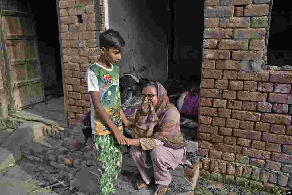 A Christian woman weeps after looking at her home vandalized by an angry Muslim mob in Pakistan on Aug. 17, 2023. 