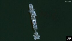 This image released by Maxar Technologies shows the USNS Roy P. Benavidez at the new pier off Gaza, May 18, 2024. (Satellite image ©2024 Maxar Technologies via AP)