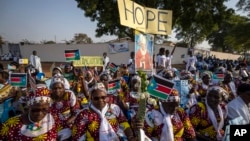 FILE - Women hold await the arrival of Pope Francis at the St. Theresa Cathedral in Juba, South Sudan, Feb. 4, 2023. In December 2024, the country is due to hold presidential elections, the culmination of a 2018 peace agreement.