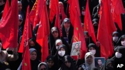 FILE - Mourners in Tehran, Iran, attend the April 4, 2023, funeral procession for Revolutionary Guard members Milad Heidari and Meghdad Mahghani, who were killed by an Israel airstrike in Syria.