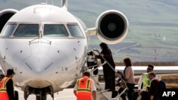 FILE - A picture taken on March 20, 2018 shows passengers climbing aboard a plane on the tarmac at the airport in the Iraqi Kurdish city of Suleimaniyah.