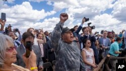Supporters photograph as President Joe Biden signs a proclamation designating the Baaj Nwaavjo I'Tah Kukveni National Monument at the Red Butte Airfield, Aug. 8, 2023, in Tusayan, Arizona.