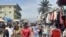 People look on at a market on the side of a road in Libreville on Sept. 2, 2023. There were demonstrations this week in the Gabonese cities of Libreville, Oyem and Franceville, as civil society groups call for an end to sanctions. 