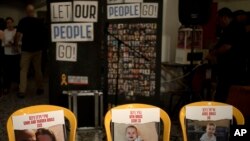 Chairs are set for missing members of the Bibas family who are held hostage in Gaza at a Passover Seder table April 11, 2024, at Israel's Kibbutz Nir Oz, where a quarter of all residents were killed or captured by Hamas on Oct. 7, 2023. 