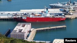 The Bibby Stockholm barge, foreground, at Portland, near Poole, Britain, Aug. 7, 2023. Asylum-seekers had been housed on the barge until traces of bacteria were found in the ship's water system. 
